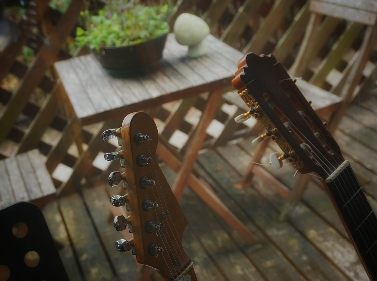 CLOSE-UP OF GUITAR ON FLOOR