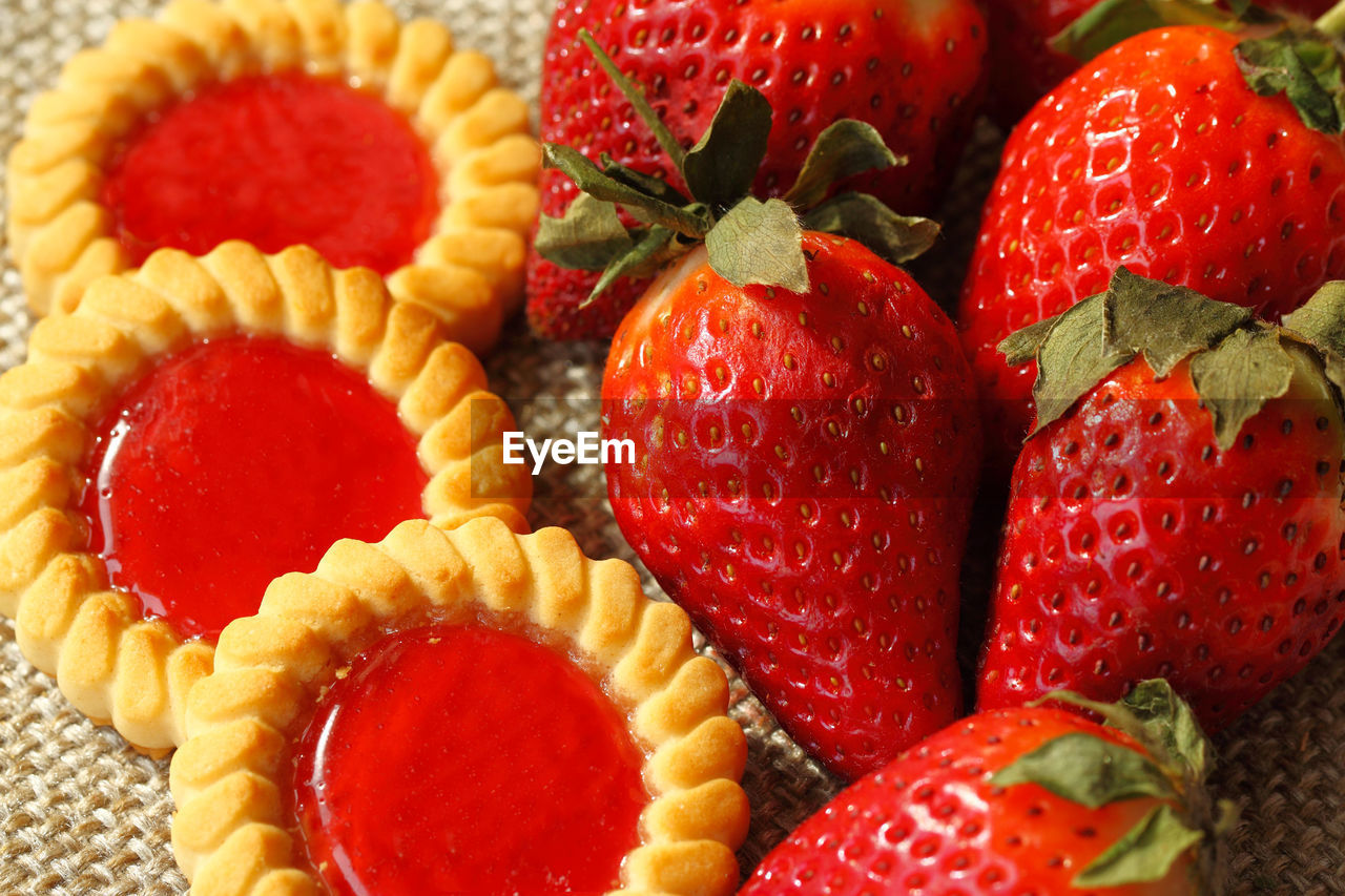 Close-up of strawberries and cookies on burlap