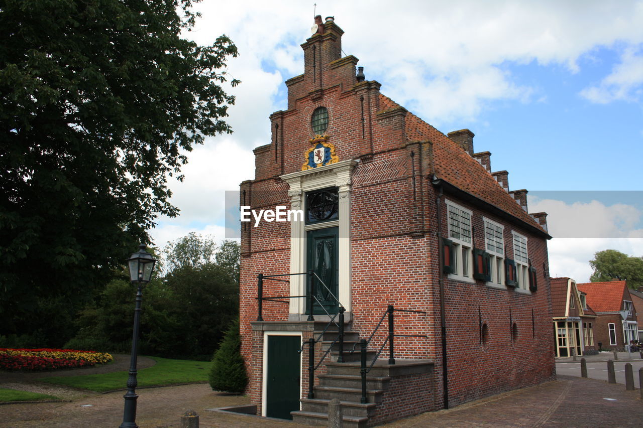 Historic brick building with step-roof, town hall in spanbroek, the netherlands