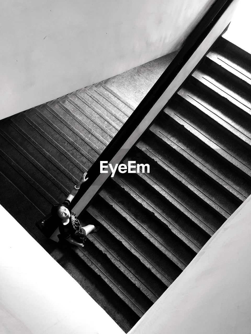 High angle view of woman walking on staircase