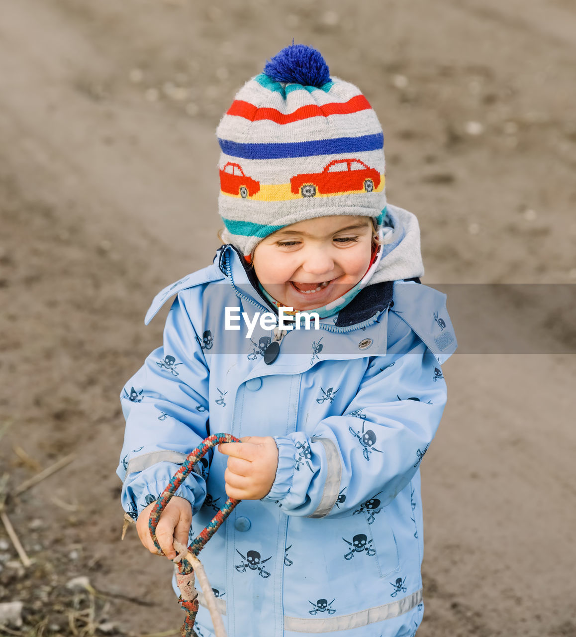 CUTE BOY STANDING IN SNOW