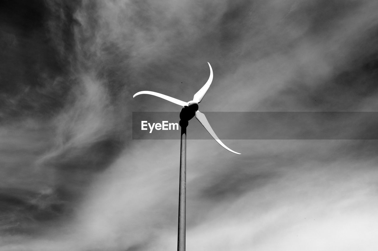 Low angle view of windmill against cloudy sky