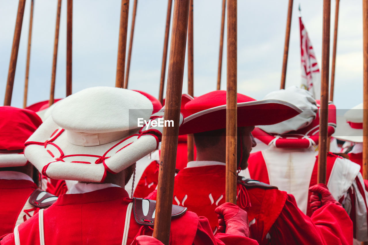 Rear view of men standing in parade