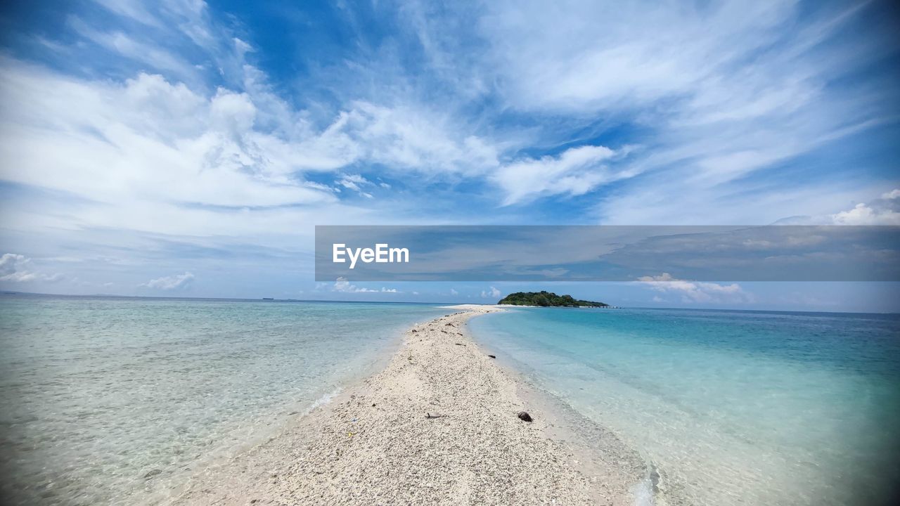 water, sky, sea, land, beach, horizon, cloud, scenics - nature, beauty in nature, ocean, nature, sand, blue, tranquility, travel destinations, environment, tranquil scene, travel, horizon over water, landscape, wave, tropical climate, body of water, holiday, trip, sunlight, vacation, island, shore, coastline, seascape, panoramic, tourism, coast, idyllic, summer, outdoors, no people, lagoon, water's edge, urban skyline, day, cloudscape, wind wave, relaxation
