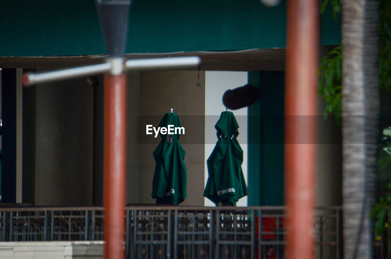 CLOTHES HANGING ON METAL FENCE