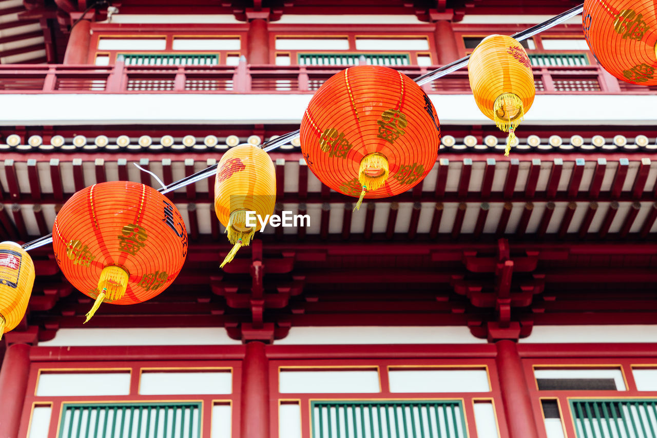 Low angle view of lanterns hanging outside building, chinatown singapore 