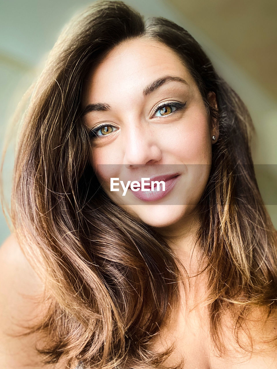 Close-up portrait of smiling young woman