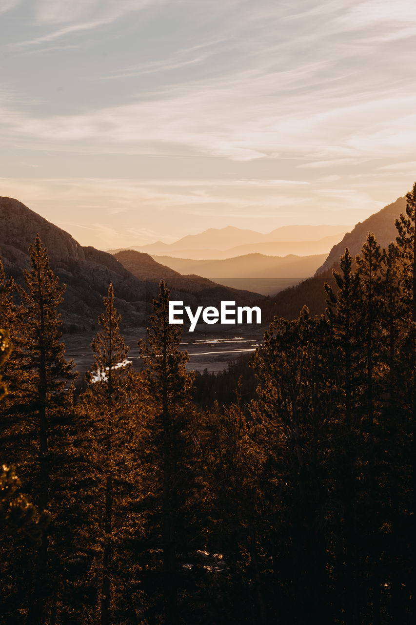 Scenic view of land and mountains against sky