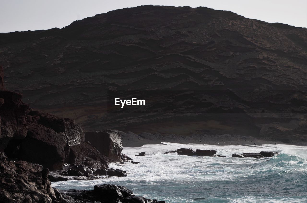 Scenic view of sea against mountain