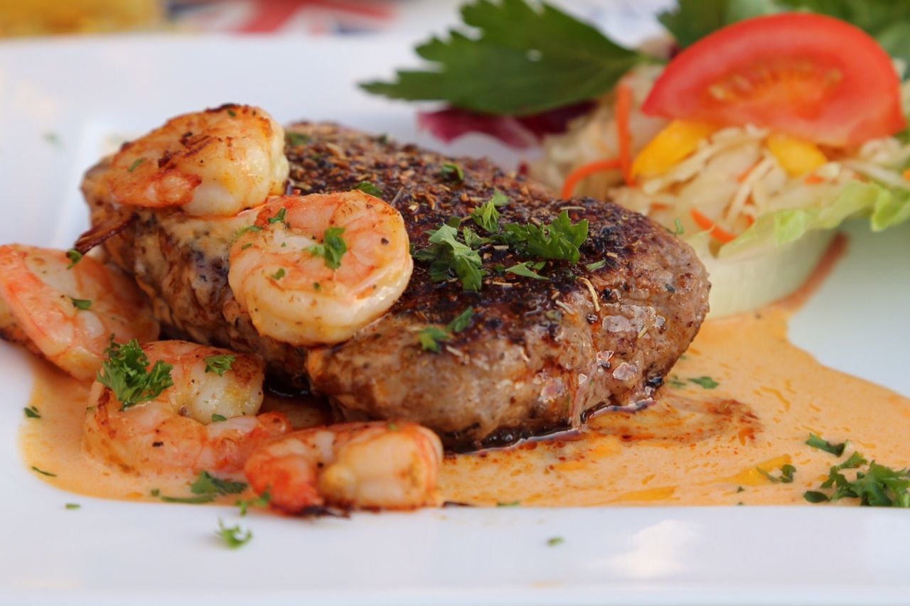 Close-up of served seafood with beef in plate