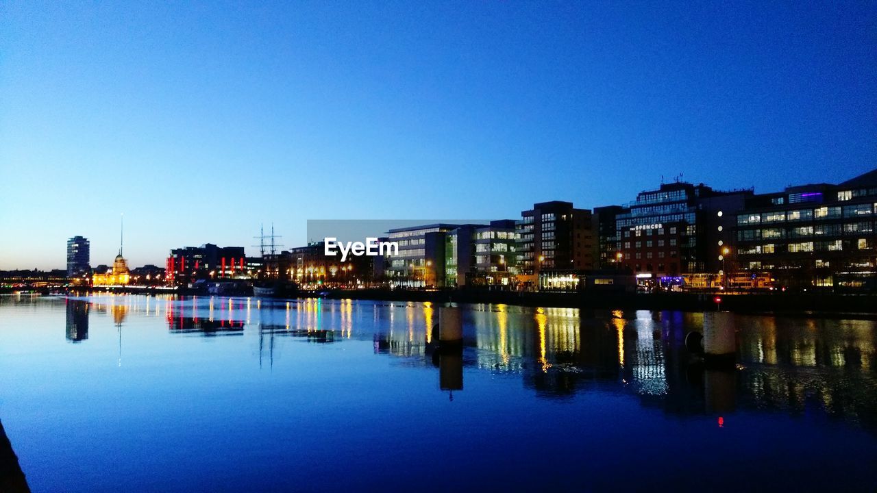 VIEW OF ILLUMINATED CITYSCAPE AT NIGHT