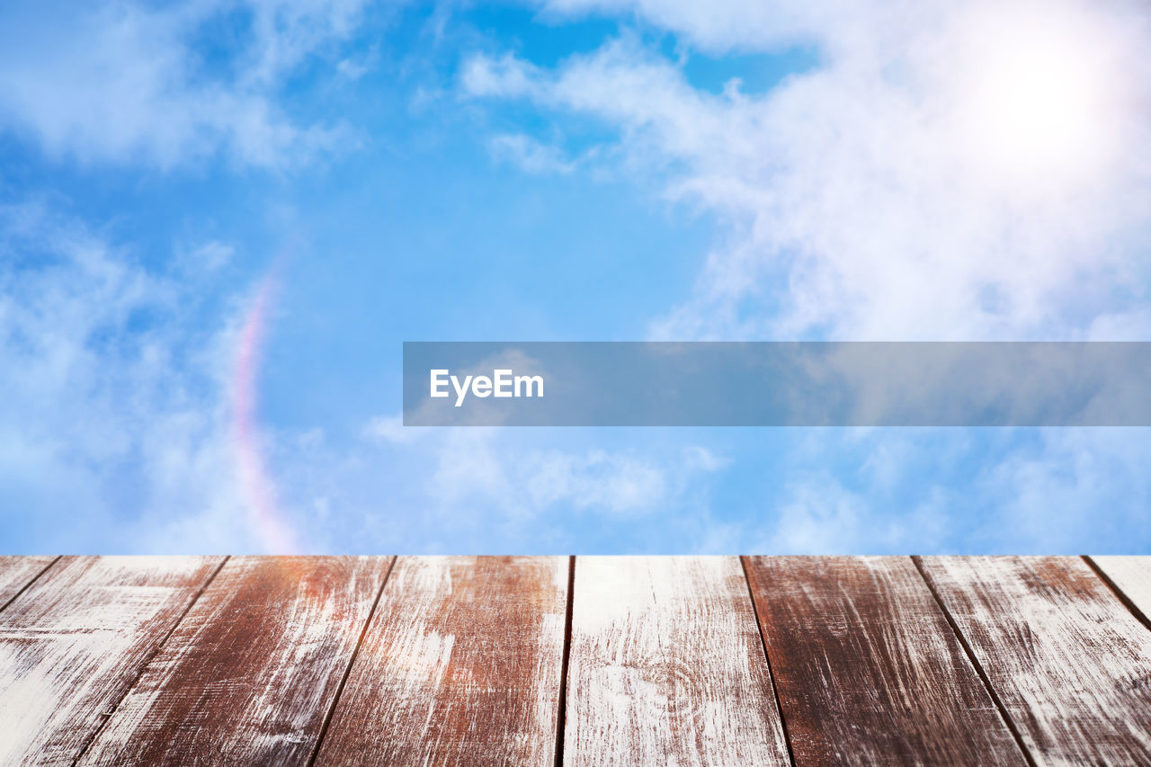 LOW ANGLE VIEW OF WOODEN WALL AGAINST SKY