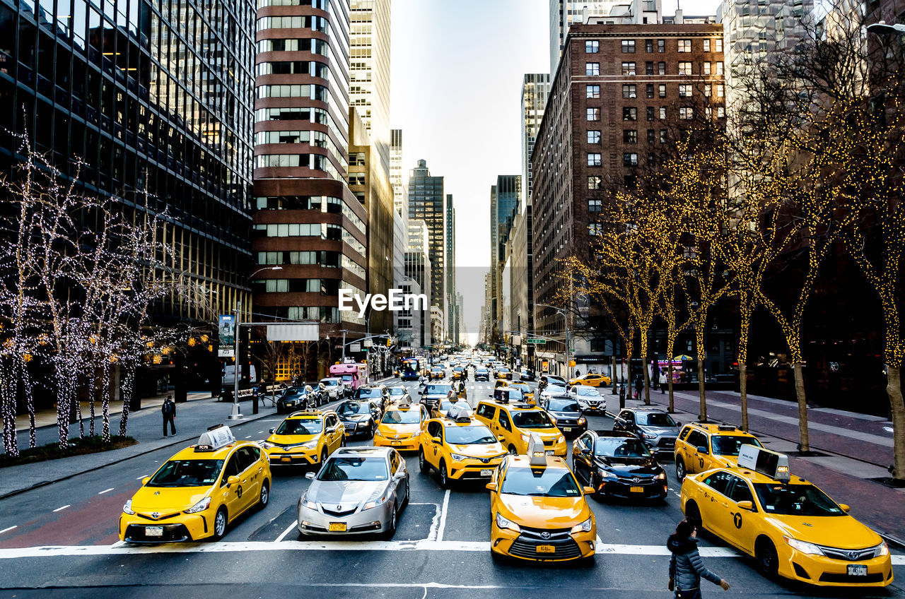 TRAFFIC ON CITY STREET AMIDST BUILDINGS