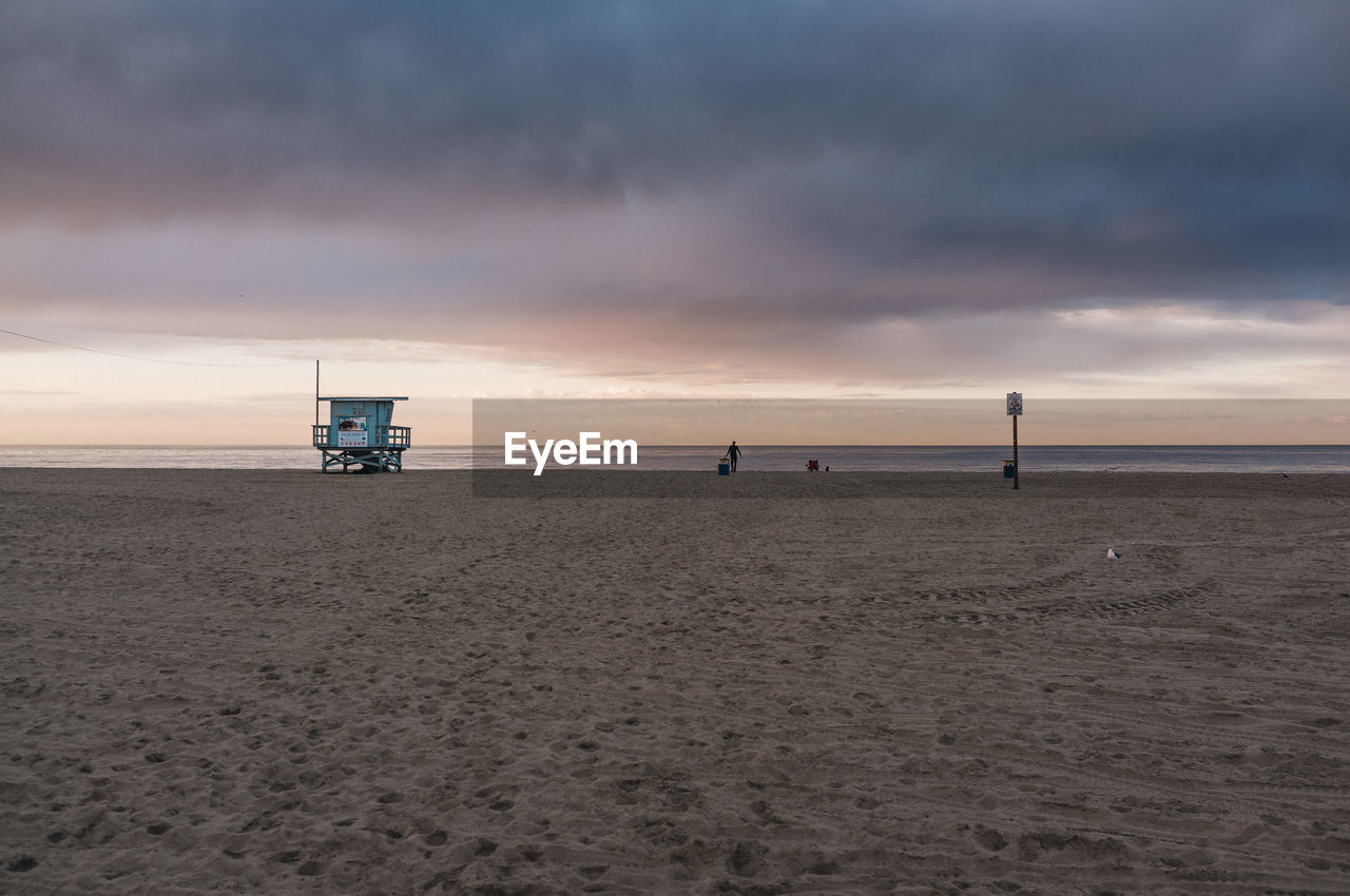 Scenic view of beach against sky during sunset