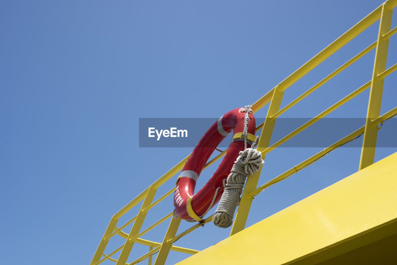 A lifebuoy ring with rope at the back of ferry boat - travel and shipping safety background