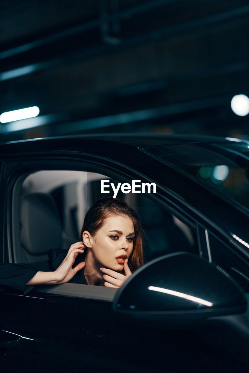 Young woman sitting in car