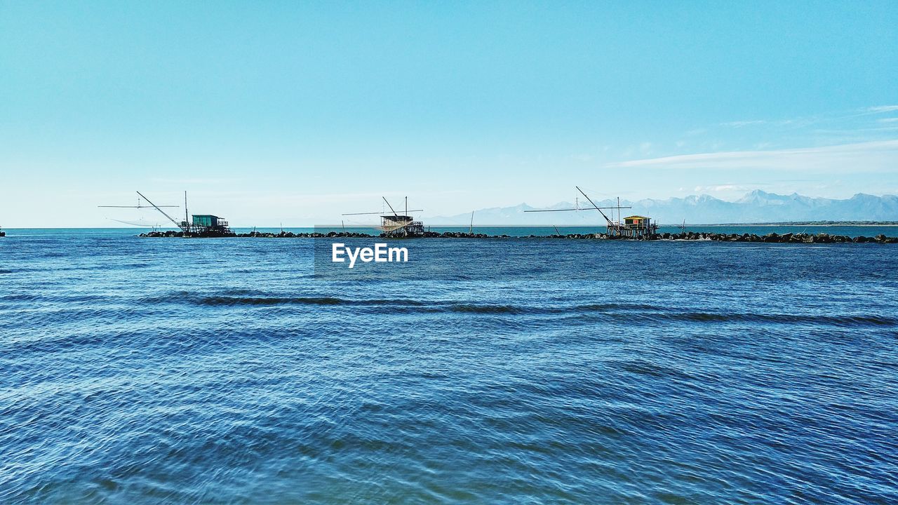 Mid distance shot of boats in calm blue water