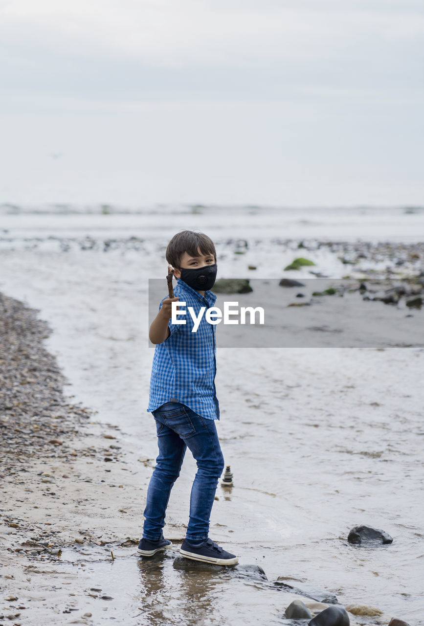 Rear view of boy on beach