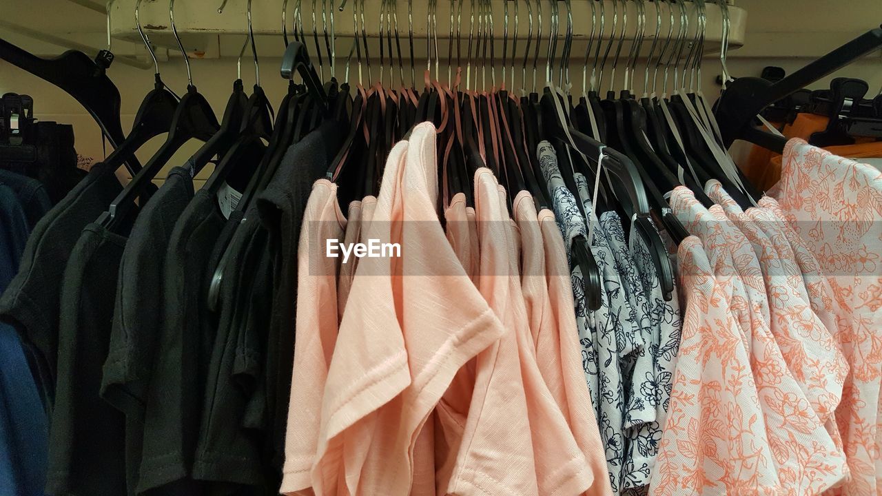 PANORAMIC SHOT OF CLOTHES HANGING IN STORE