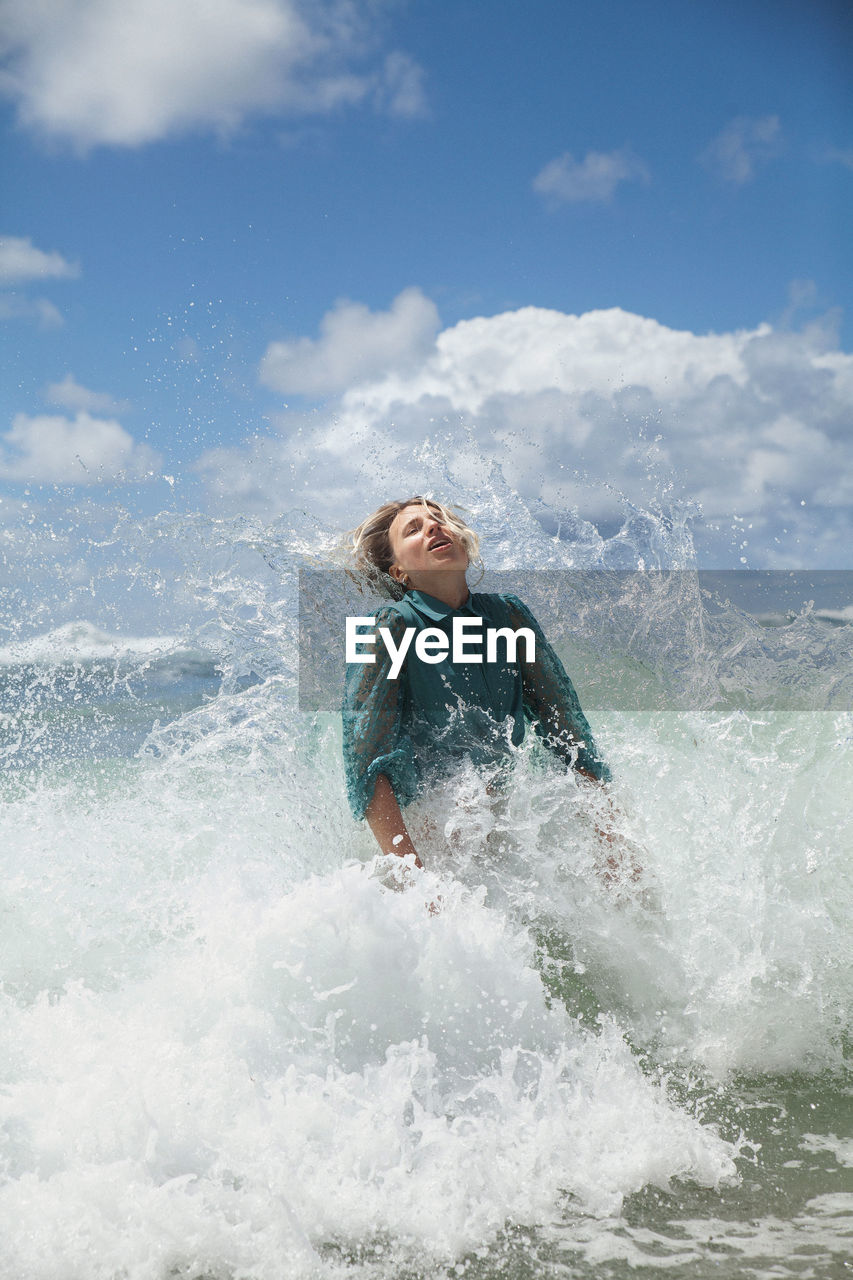 Portrait of young woman swimming in sea