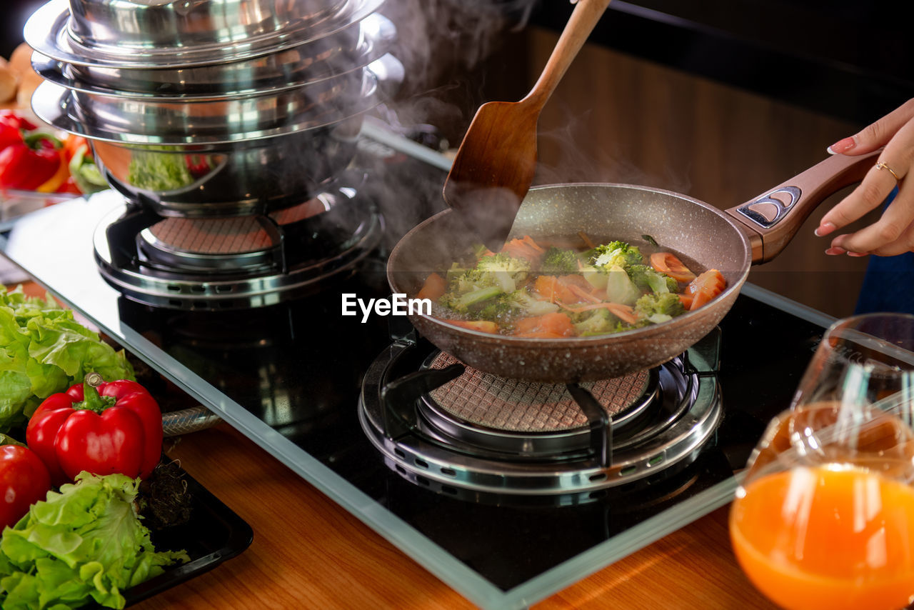 cropped hand of person preparing food in bowl on table