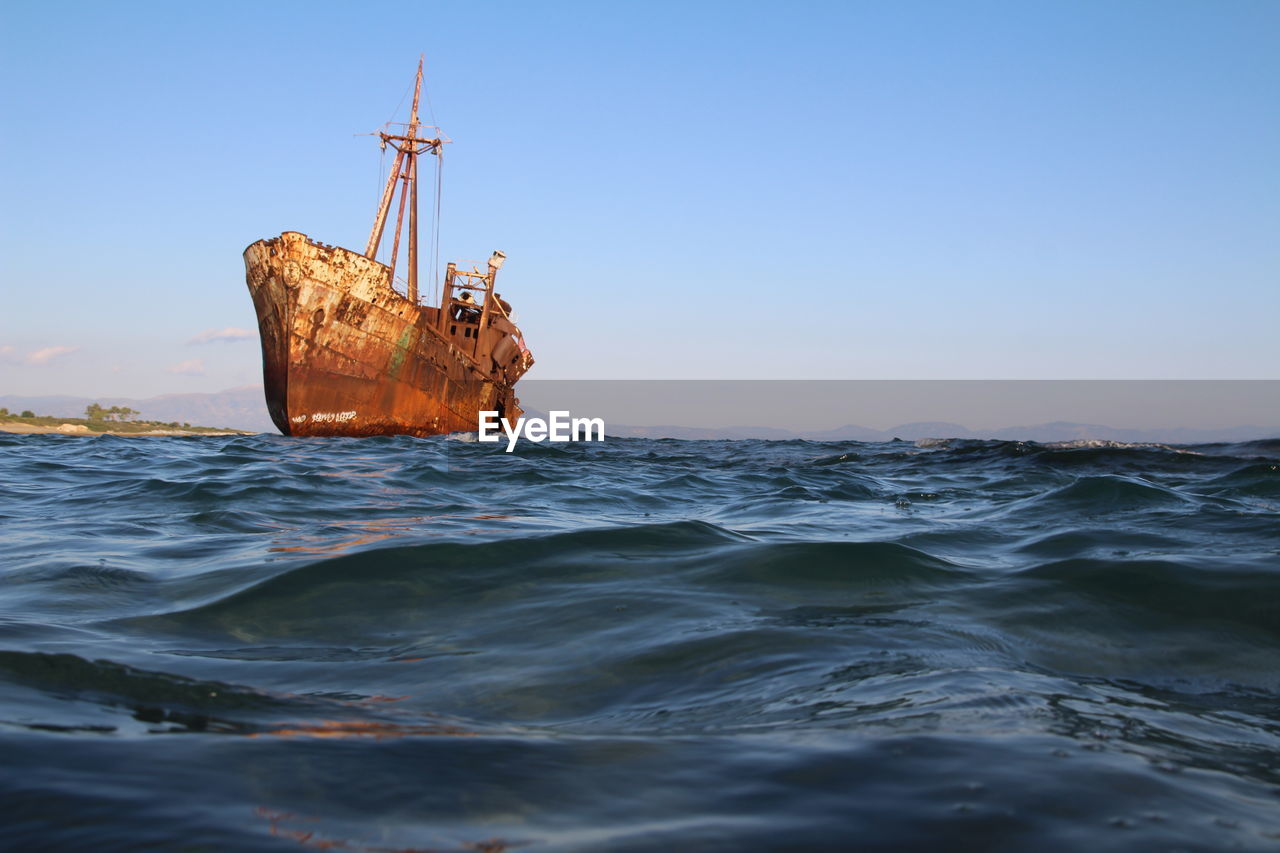 Sailboat on sea against clear sky