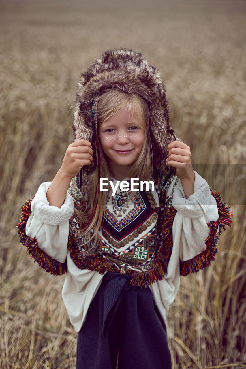 Girl indian shaman blonde in a poncho and a dream catcher