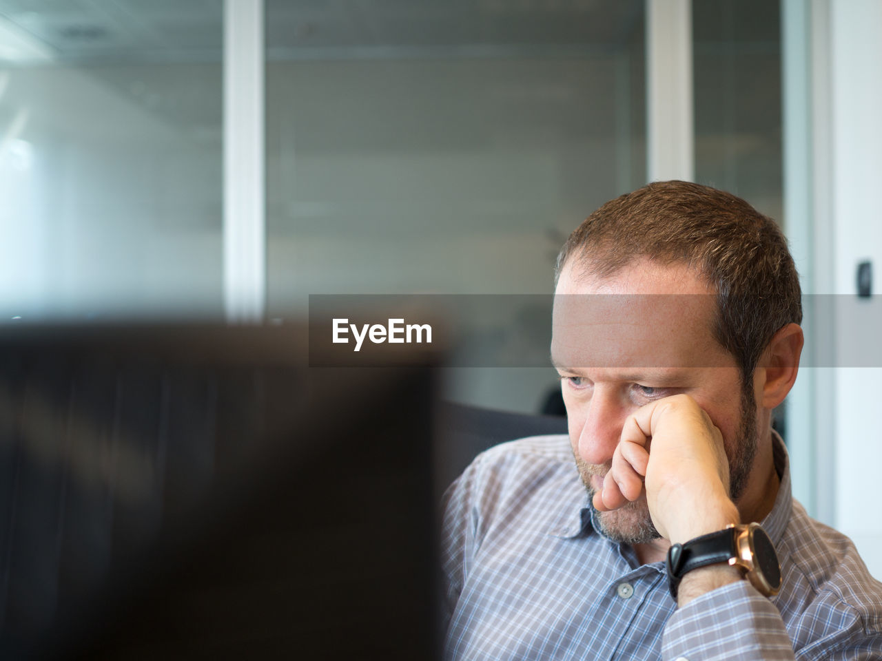 Thoughtful businessman sitting at office