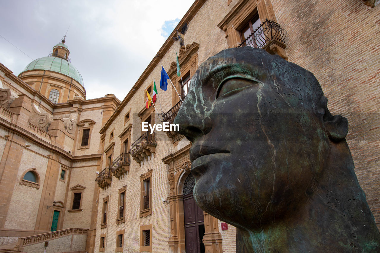 low angle view of statue against historic building