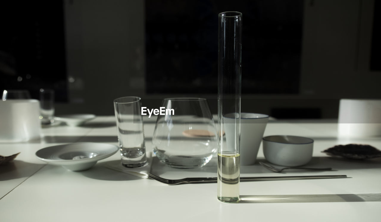 CLOSE-UP OF WINE GLASSES ON TABLE IN KITCHEN