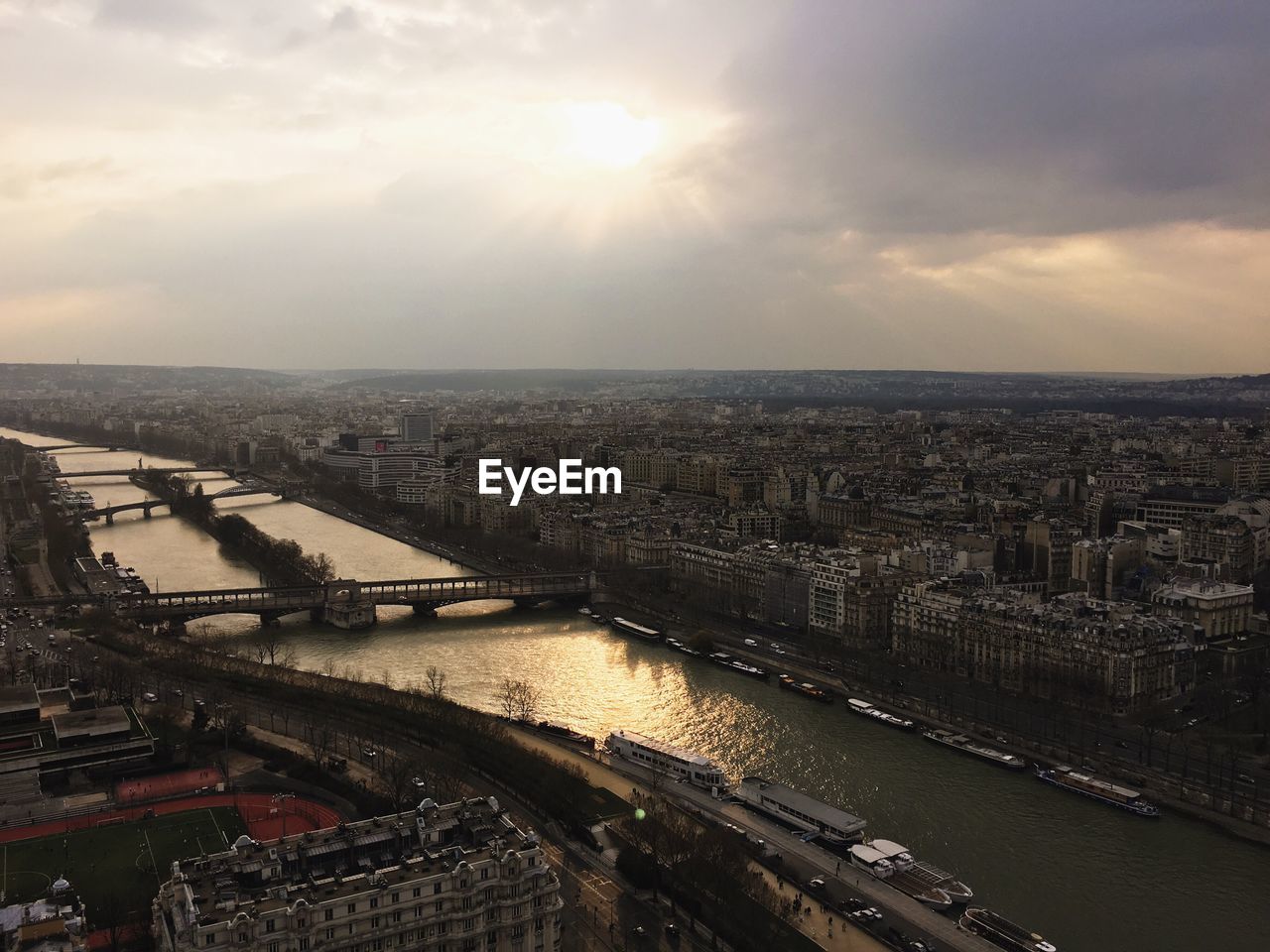 High angle view of seine river amidst cityscape against sky during sunset