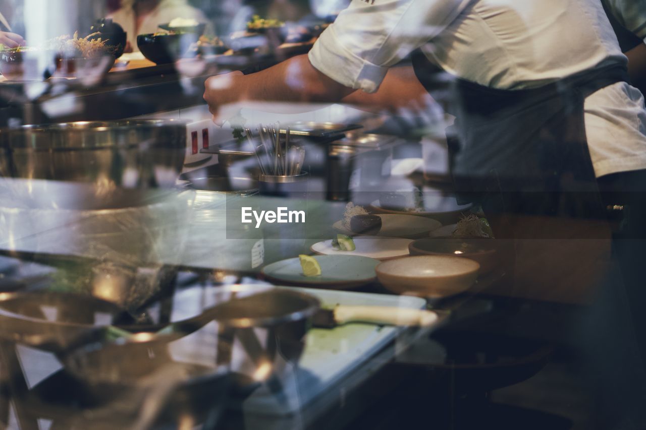 midsection of man preparing food at restaurant