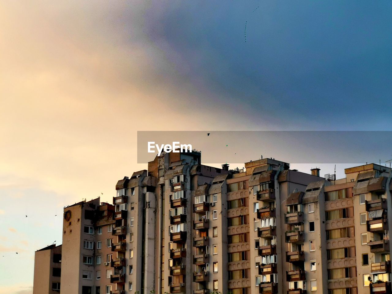 Low angle view of buildings against sky during sunset