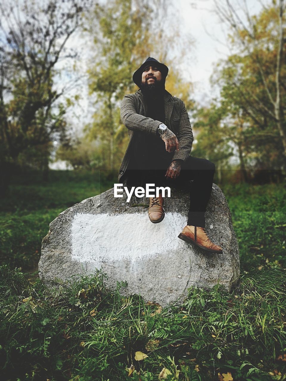 Mature man sitting on rock