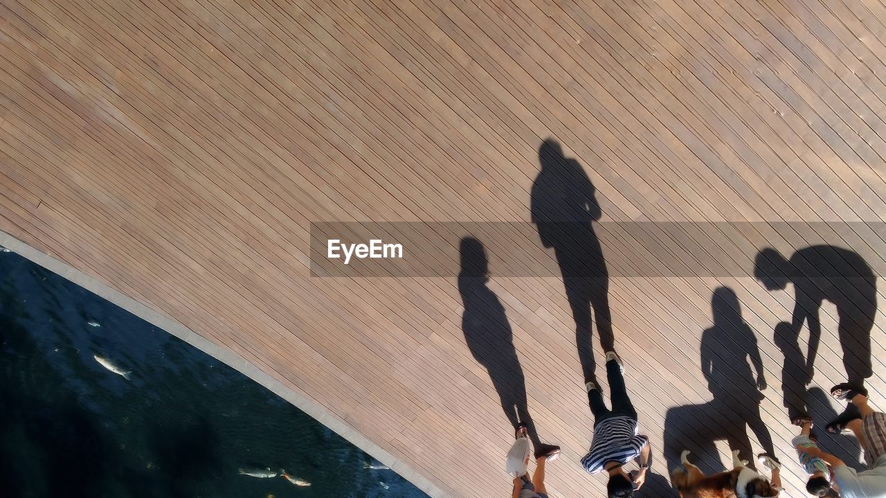 High angle view of people standing on wooden boardwalk