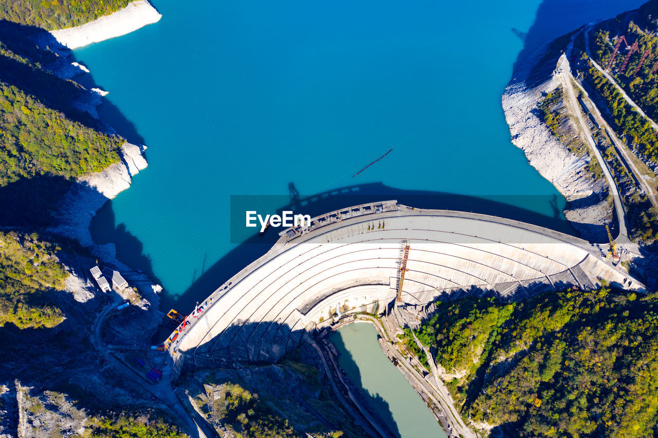 HIGH ANGLE VIEW OF TREES AND PLANTS AGAINST BLUE SKY