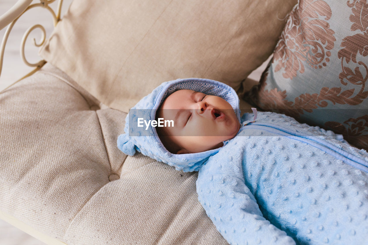 High angle view of baby sleeping in bed