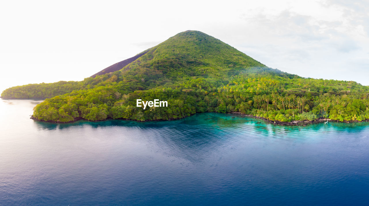 Scenic view of sea and mountains against sky