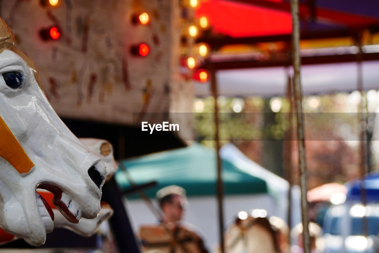 Close-up side view of cropped merry-go-round