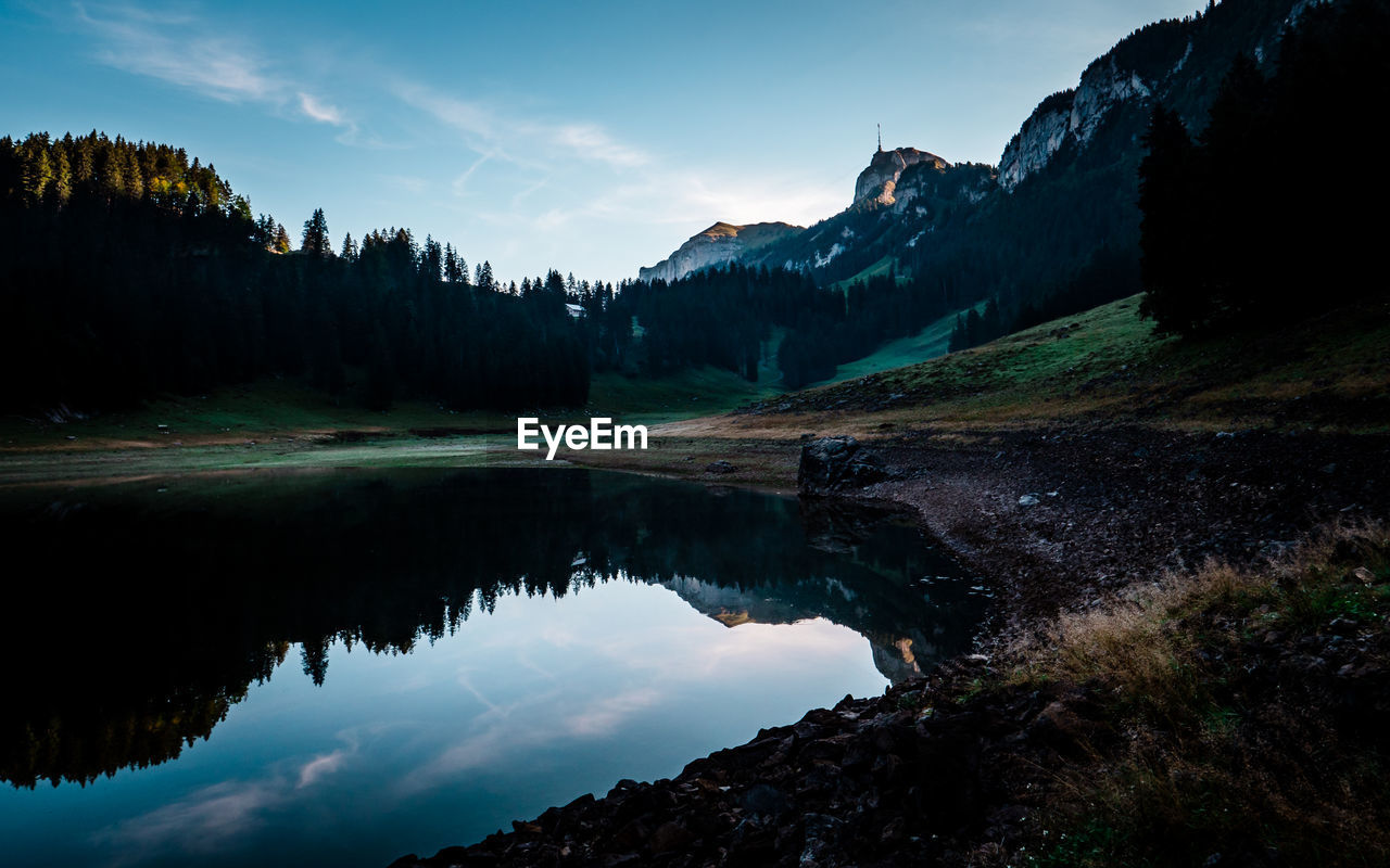 Scenic view of lake and mountains against sky
