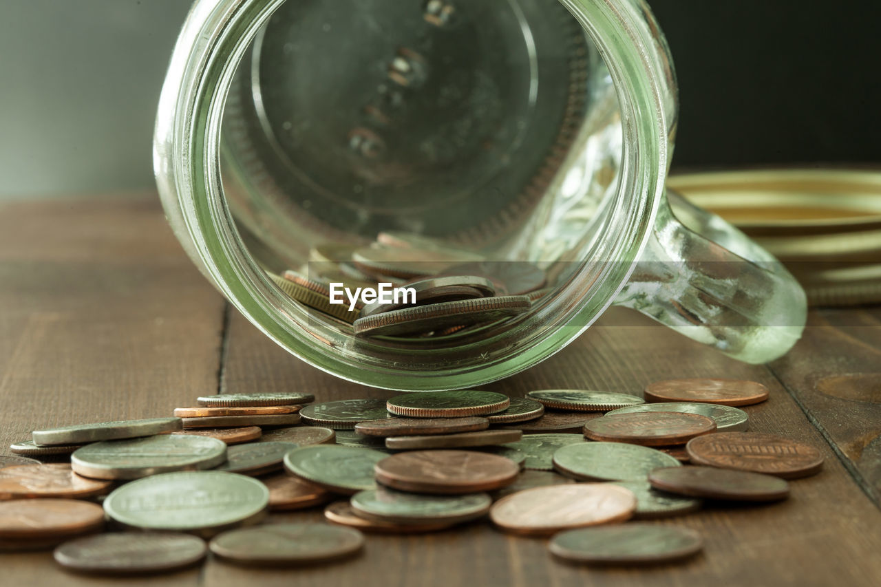 Close-up of coins in jar on table