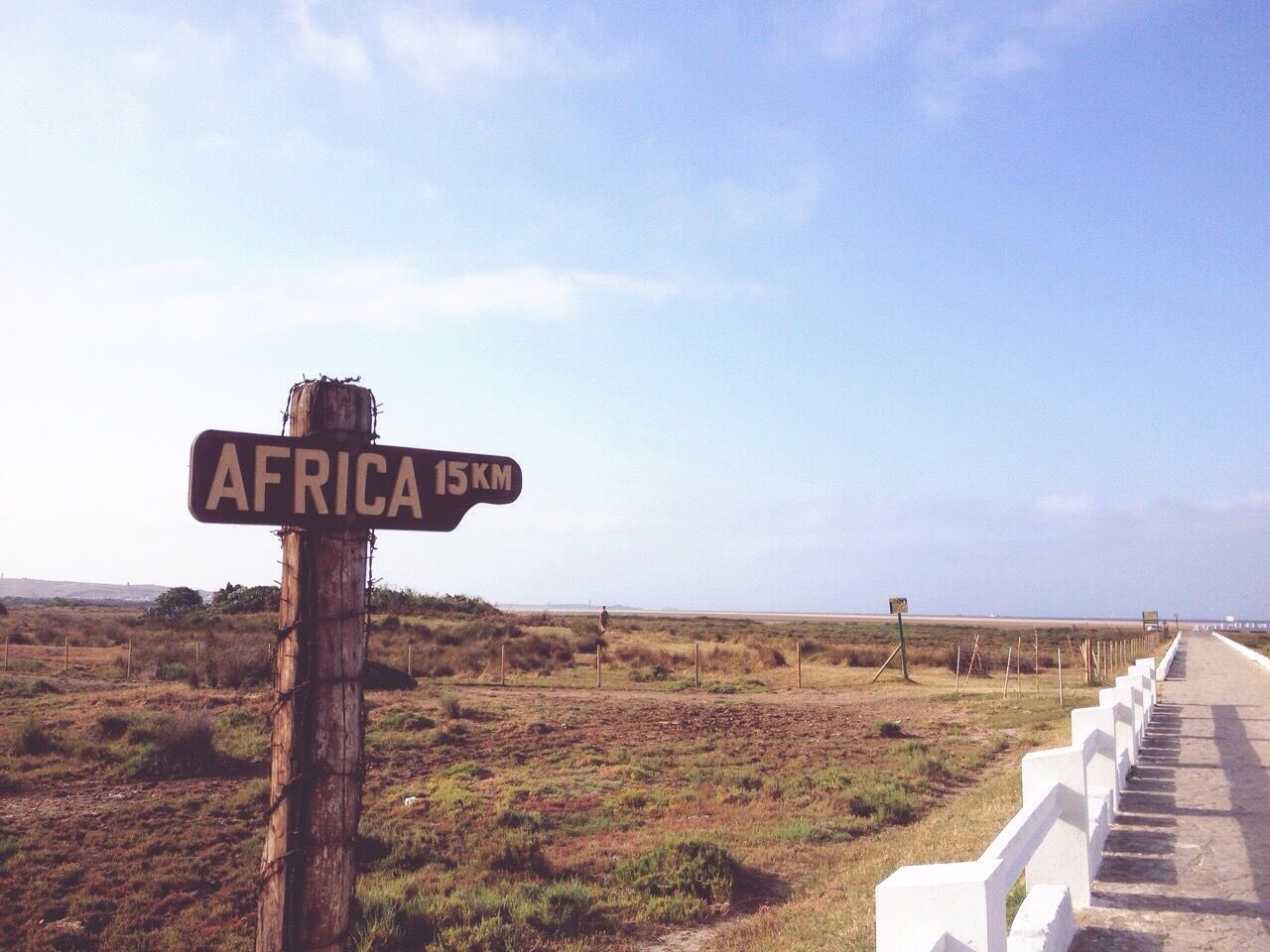 Information sign on landscape against sky