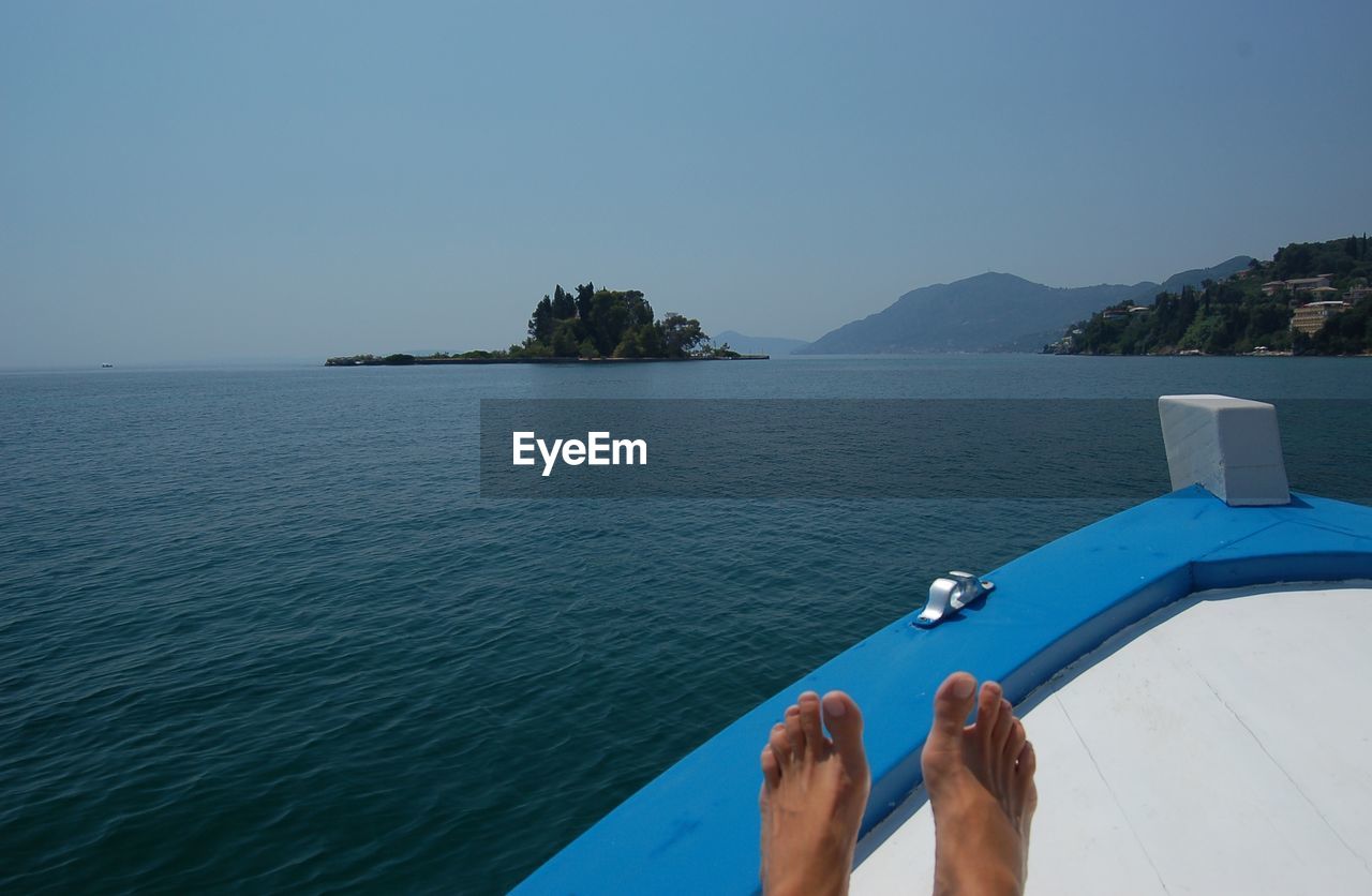 Low section of person in boat on sea