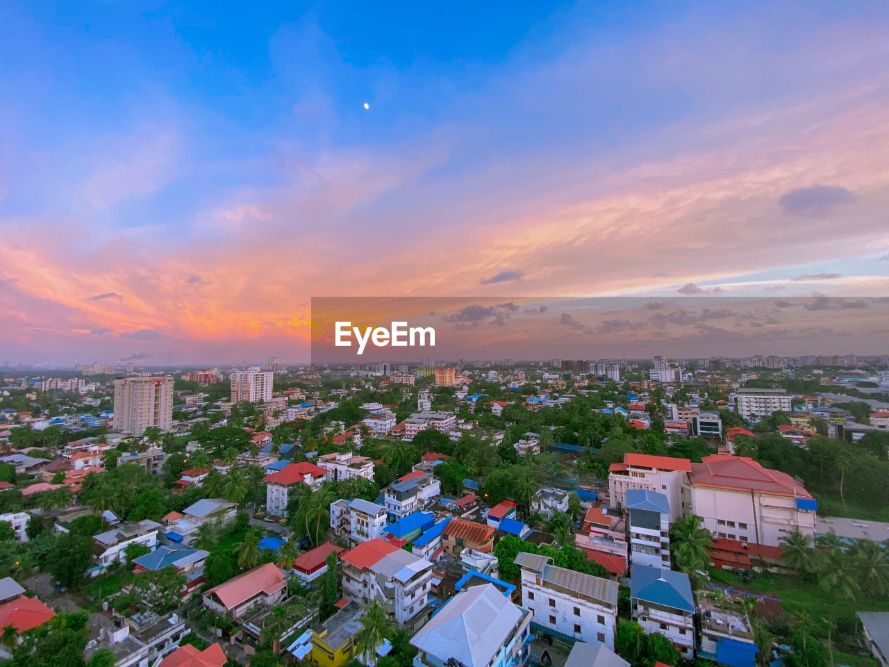 High angle shot of townscape against sky at sunset