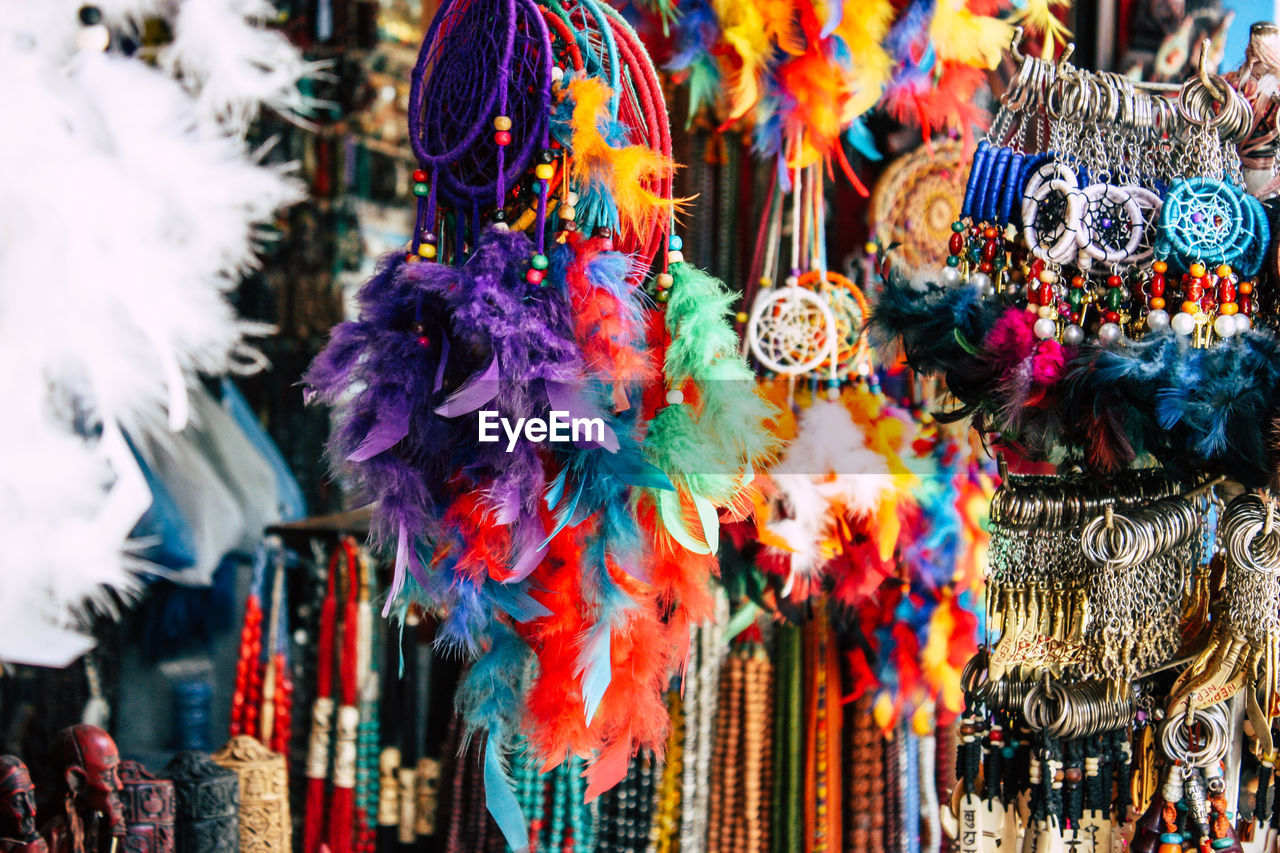 CLOSE-UP OF DECORATIONS HANGING IN MARKET STALL