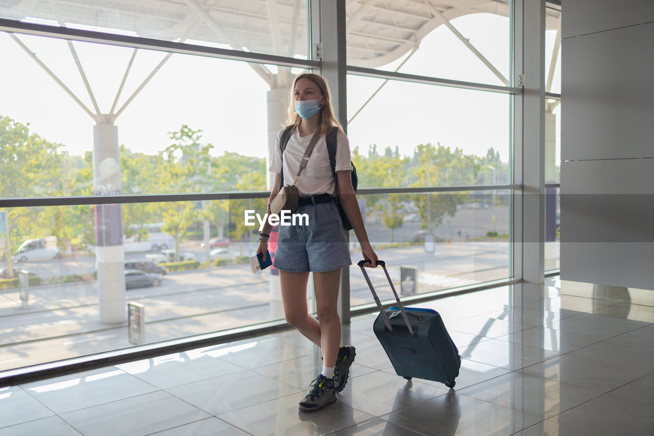 WOMAN WITH UMBRELLA WALKING ON FLOOR