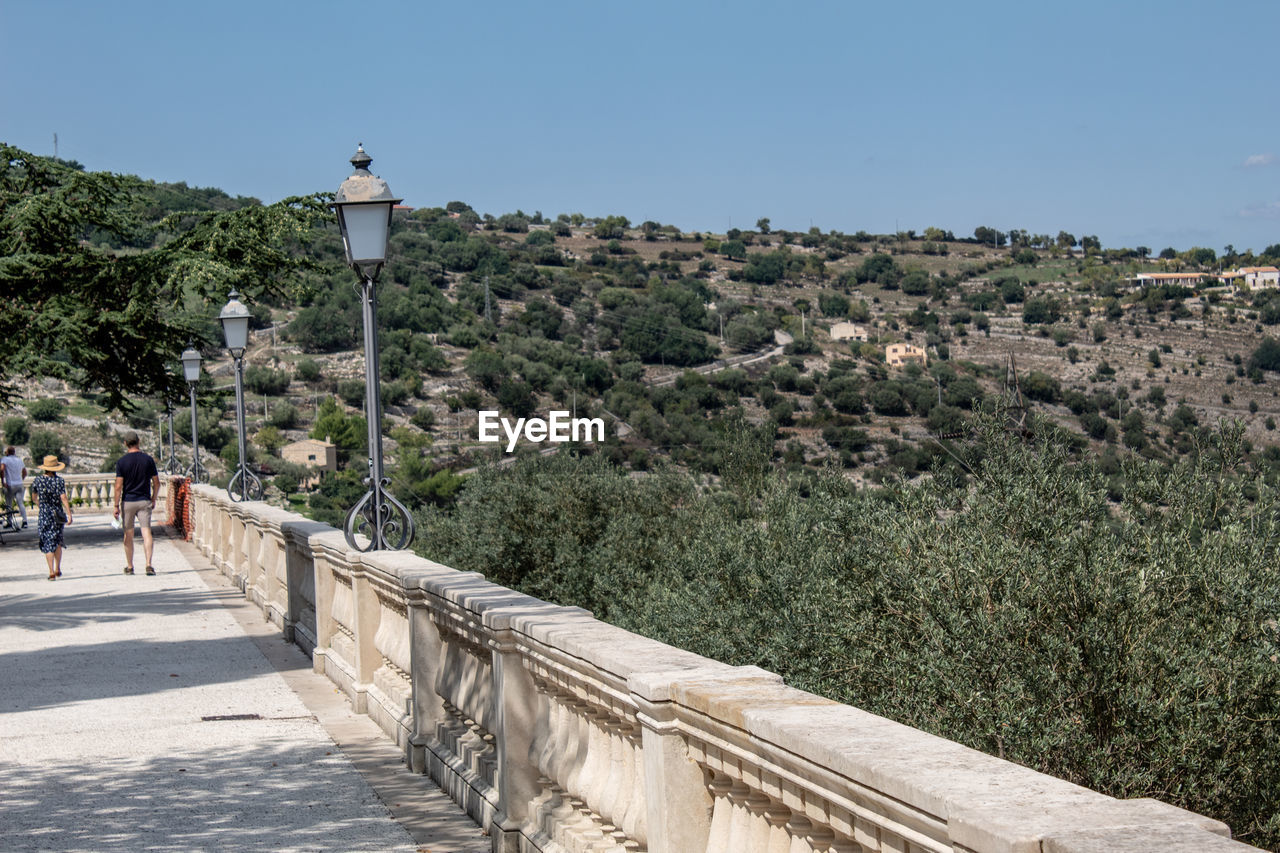 A path in the garden of ragusa ibla runs along the ravine with its view of the hills