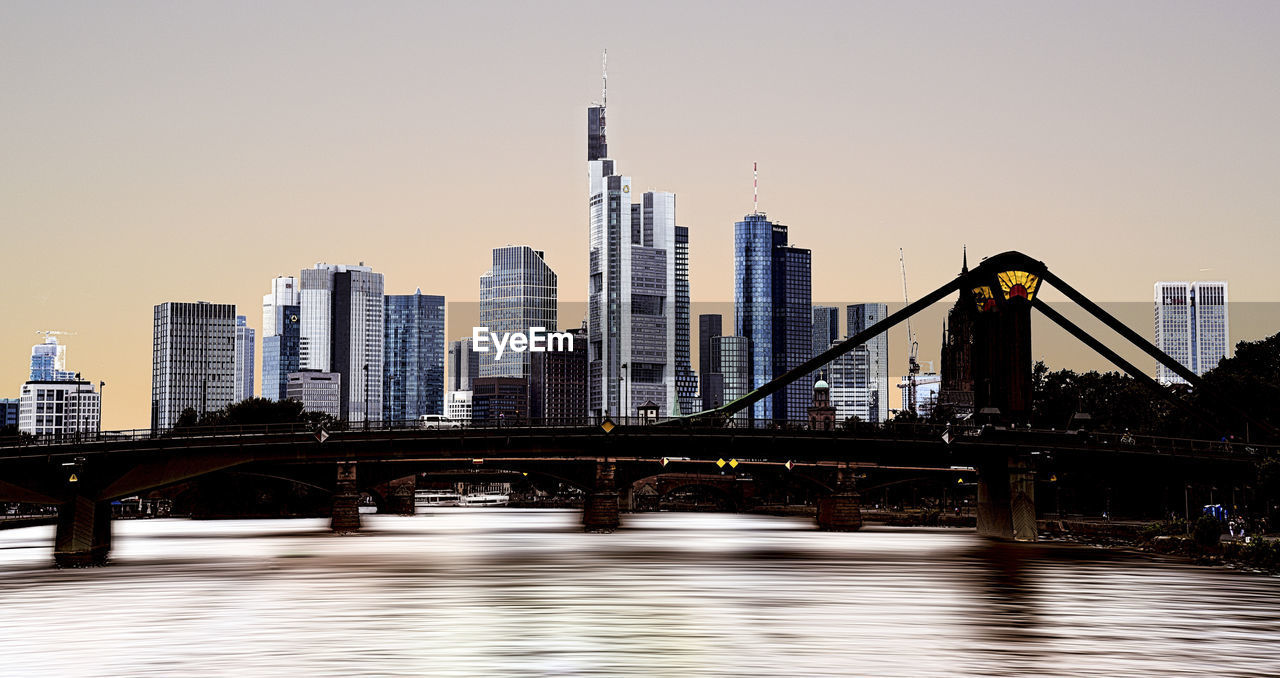 Bridge over river with buildings in background