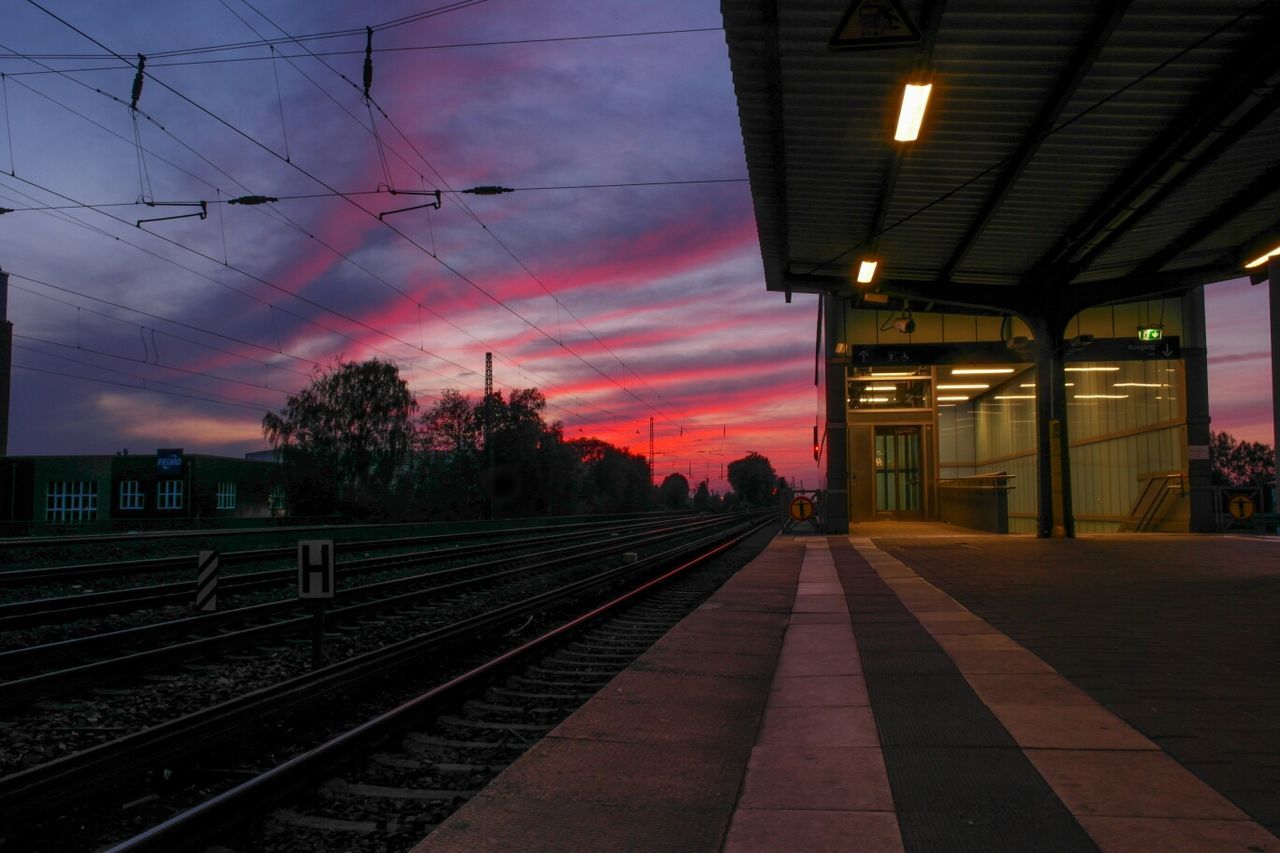 Empty railroad station platform at dusk