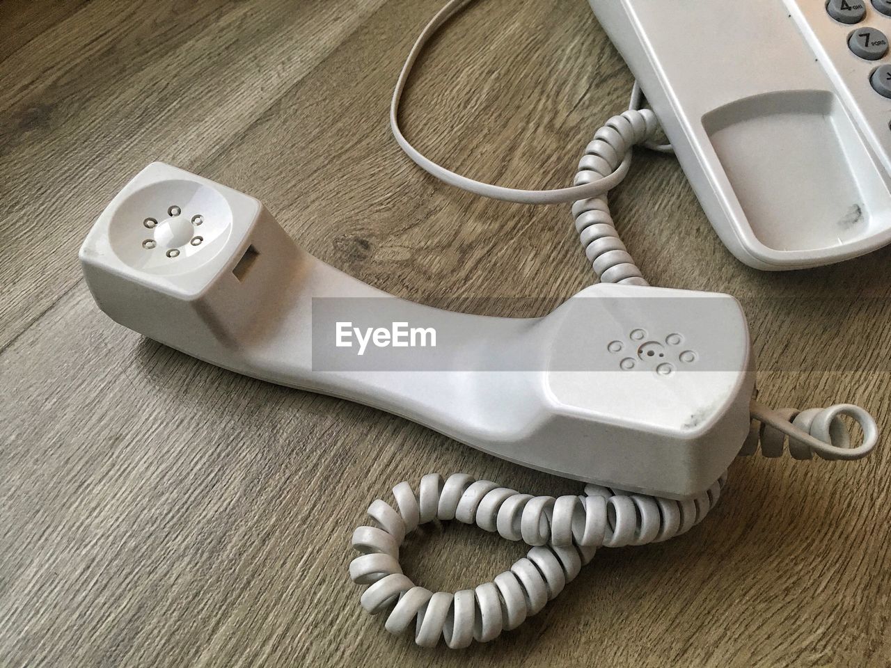 Close-up of telephone on wooden table